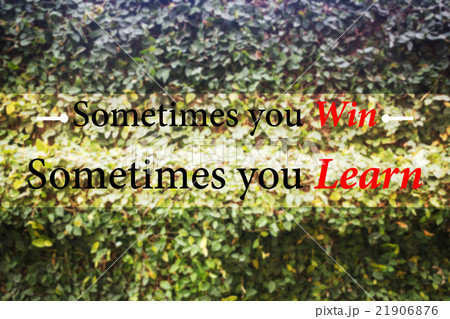 Win and learn inspiration message on green wall 21906876
