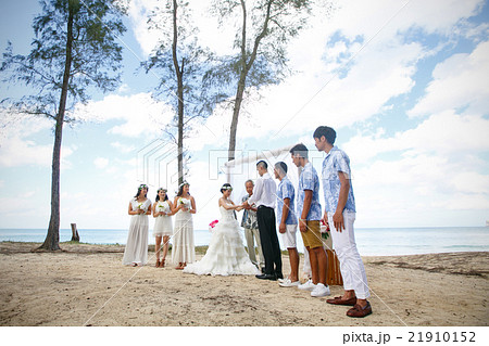 ビーチウェディングをする新郎新婦 21910152