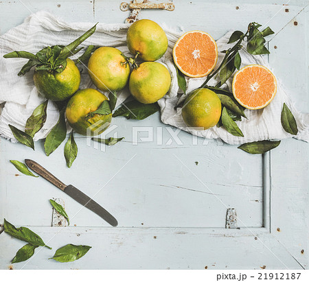 Fresh Turkish tangerines with leaves over blue 21912187