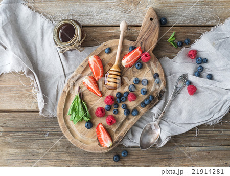 Blueberries, raspberries, strawberries, honey and 21914281