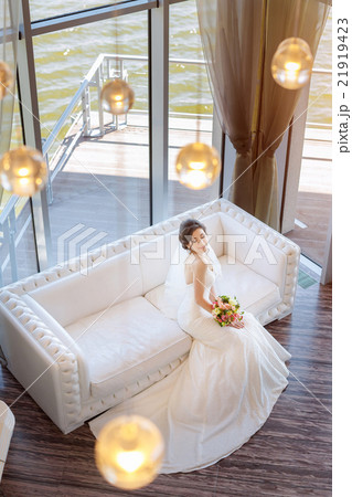 Beautiful bride against a big window indoors 21919423