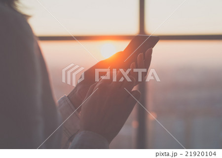 Close-up of woman holding smartphone in her hands Close-up of woman holding smartphone in her hands 21920104
