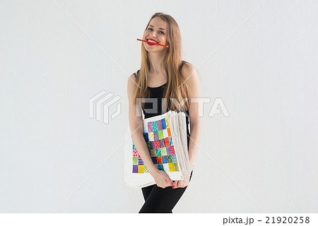 Front view portrait of young female artist holding 21920258