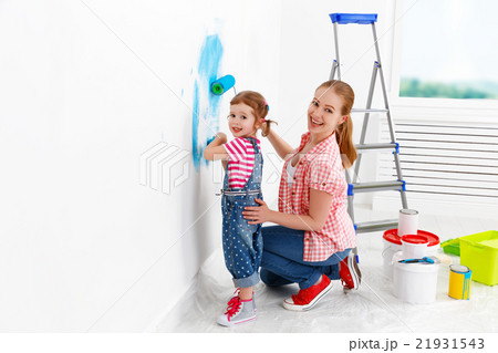 happy family mother and child daughter making repairs, paint wal happy family mother and child daughter making repairs, paint wal 21931543