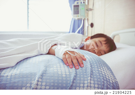 Asian boywith saline intravenous (IV). Health care Asian boywith saline intravenous (IV). Health care 21934225