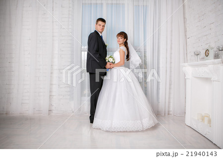 Bride and groom are  in a hotel room 21940143