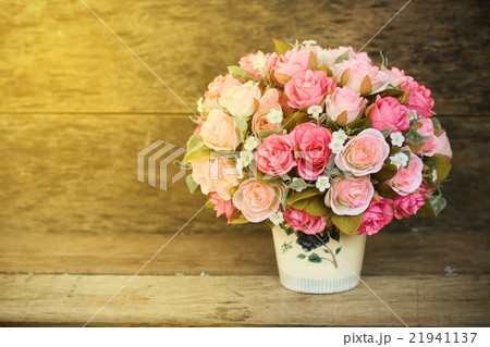 Plastic flowers with wooden background in vintage Plastic flowers with wooden background in vintage 21941137