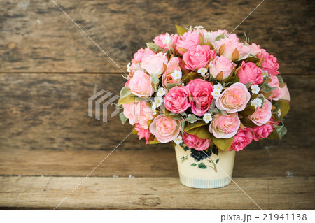 Plastic flowers with wooden background in vintage Plastic flowers with wooden background in vintage 21941138