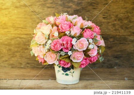 Plastic flowers with wooden background in vintage Plastic flowers with wooden background in vintage 21941139