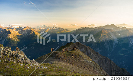 Warm light at sunrise on mountain peaks, ridges and valleys Warm light at sunrise on mountain peaks, ridges and valleys 21954637