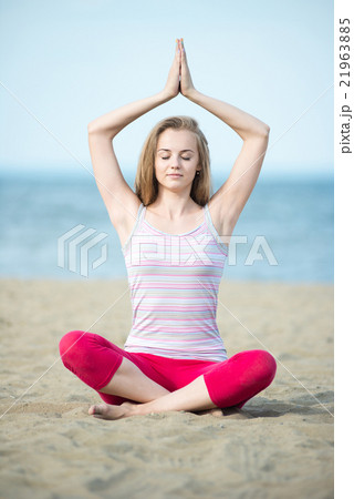 Young lady practicing yoga. Workout near ocean sea Young lady practicing yoga. Workout near ocean sea 21963885