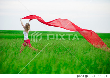 Young lady runing with tissue in green field Young lady runing with tissue in green field 21963901
