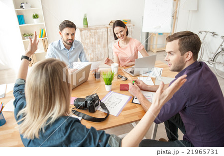 Cheerful creative team is working with joy Cheerful creative team is working with joy 21965731