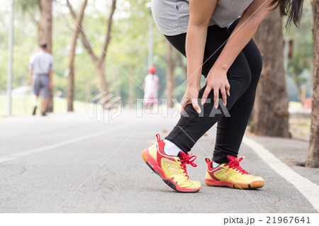 Cramp. Woman holding sore leg muscle while jogging Cramp. Woman holding sore leg muscle while jogging 21967641