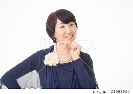 華やかな服装をした50代の女性の写真素材