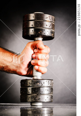 male hand is holding metal barbell 21985138