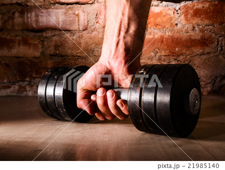 male hand is holding metal barbell 21985140