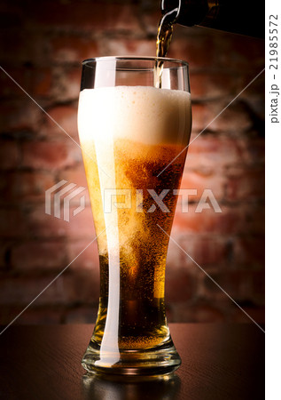 glass of lager on table 21985572
