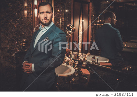 Well-dressed man in luxury bathroom interior. 21987111