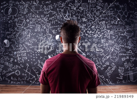 Student against a big blackboard with mathematical 21989349