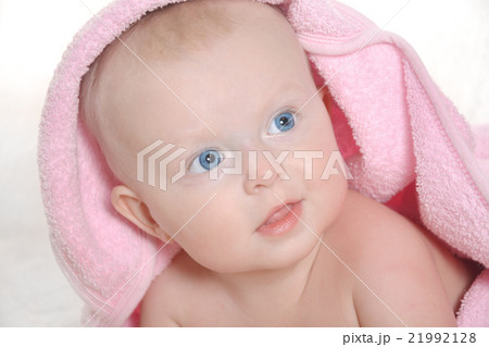Adorable baby girl under a pink towel 21992128