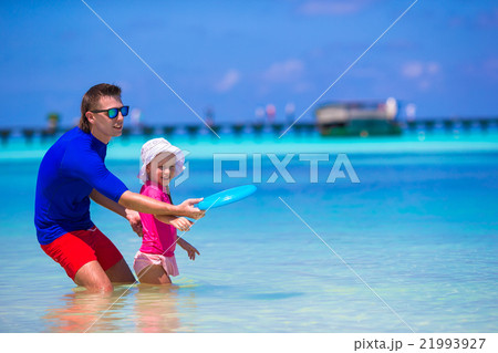 Father and daughter playing with flying disk at 21993927