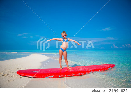 Little adorable girl practice surfing position at 21994825