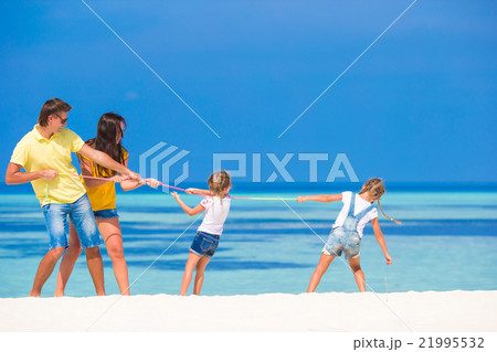 Happy family having fun on white beach  21995532