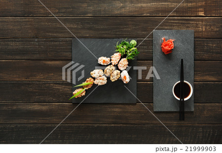 Set of sushi maki and rolls at black rustic wood. 21999903
