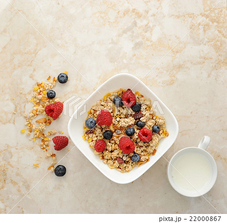 Muesli cereal with raspberries and blueberries Muesli cereal with raspberries and blueberries 22000867