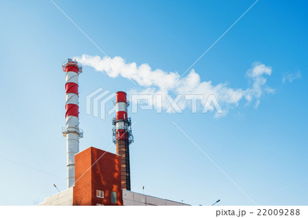 Boiler house chimney. Steam against the blue sky. 22009288