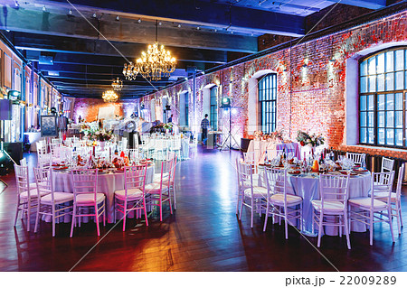 Celebration hall with tables set for banquet. Celebration hall with tables set for banquet. 22009289