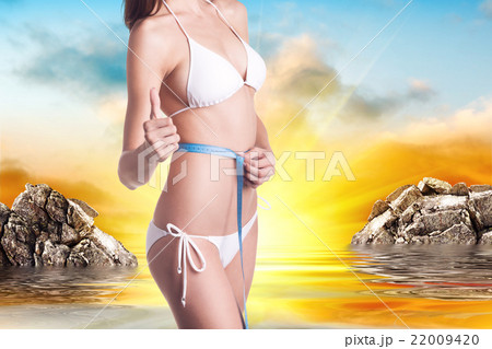 Woman with perfect body and measuring tape Woman with perfect body and measuring tape 22009420
