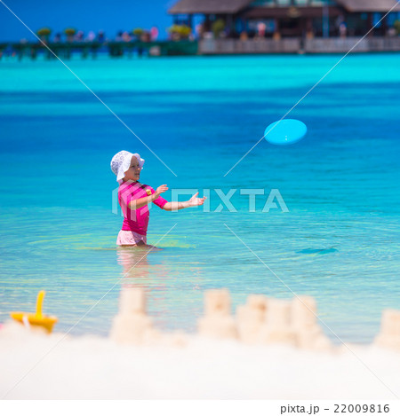 Little girl playing with flying disc at white 22009816