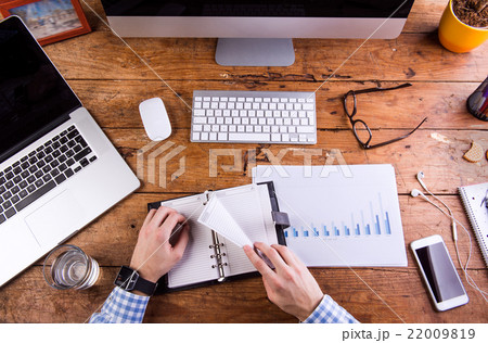 Businessman holding personal organizer. Gadgets 22009819