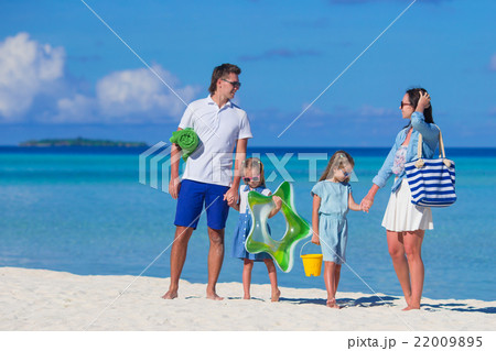 Happy family during summer vacation on white beach Happy family during summer vacation on white beach 22009895