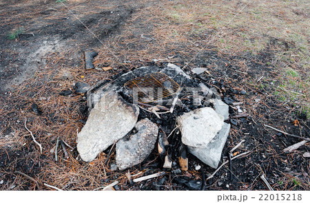 Used fire pit with stones and cinders. 22015218