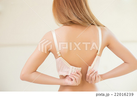 Photo Group of Back View a Young Woman Taking Off Her Bra Stock