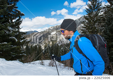 Man during a trek in the mountains in winter Man during a trek in the mountains in winter 22025006