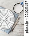 Ceramic plate with fork and cup of milk on table 22025157