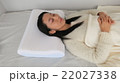 高めの枕で横になって眠っている女性 22027338