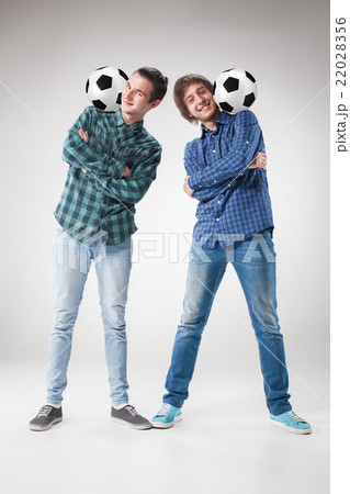 The two boys with balls on gray background The two boys with balls on gray background 22028356