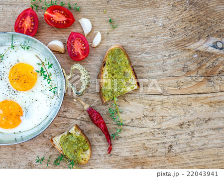 Breakfast set with fried egg on a wooden desk 22043941