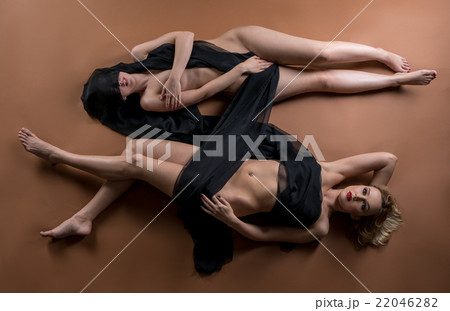 Top view of two nude women posing with fabric Top view of two nude women posing with fabric 22046282