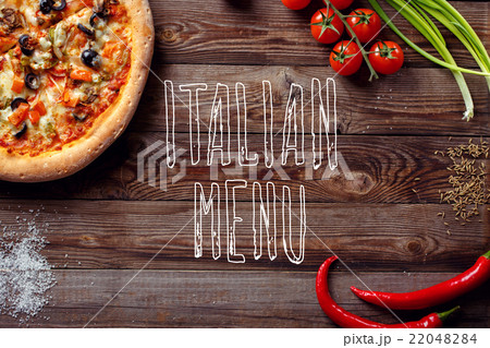 Italian pizza with tomatoes on a wooden table, top Italian pizza with tomatoes on a wooden table, top 22048284