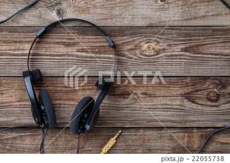 Headphones over wooden table. 22055738