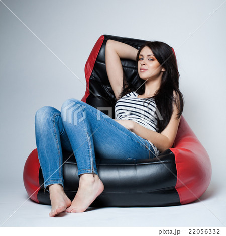 beautiful brunette lying on bean bag beautiful brunette lying on bean bag 22056332