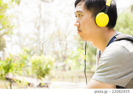 Young man listening to music with headphone Young man listening to music with headphone 22082935