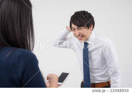 女性に謝る若いビジネスマン 22088930