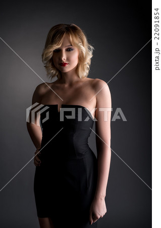 Pretty blonde dressed in black cocktail dress 22091854